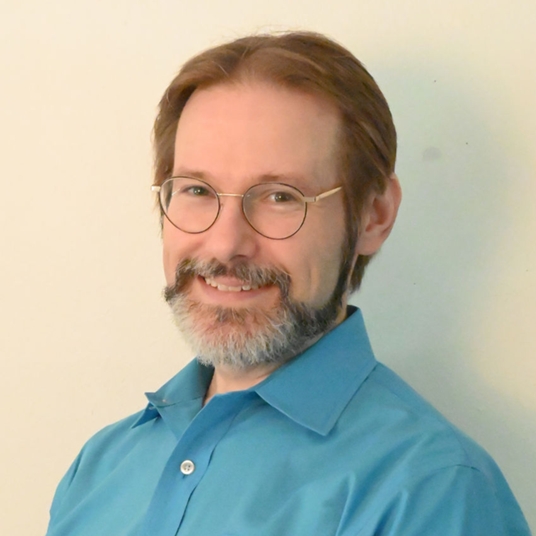 Hans Cummings (he/him) head shot